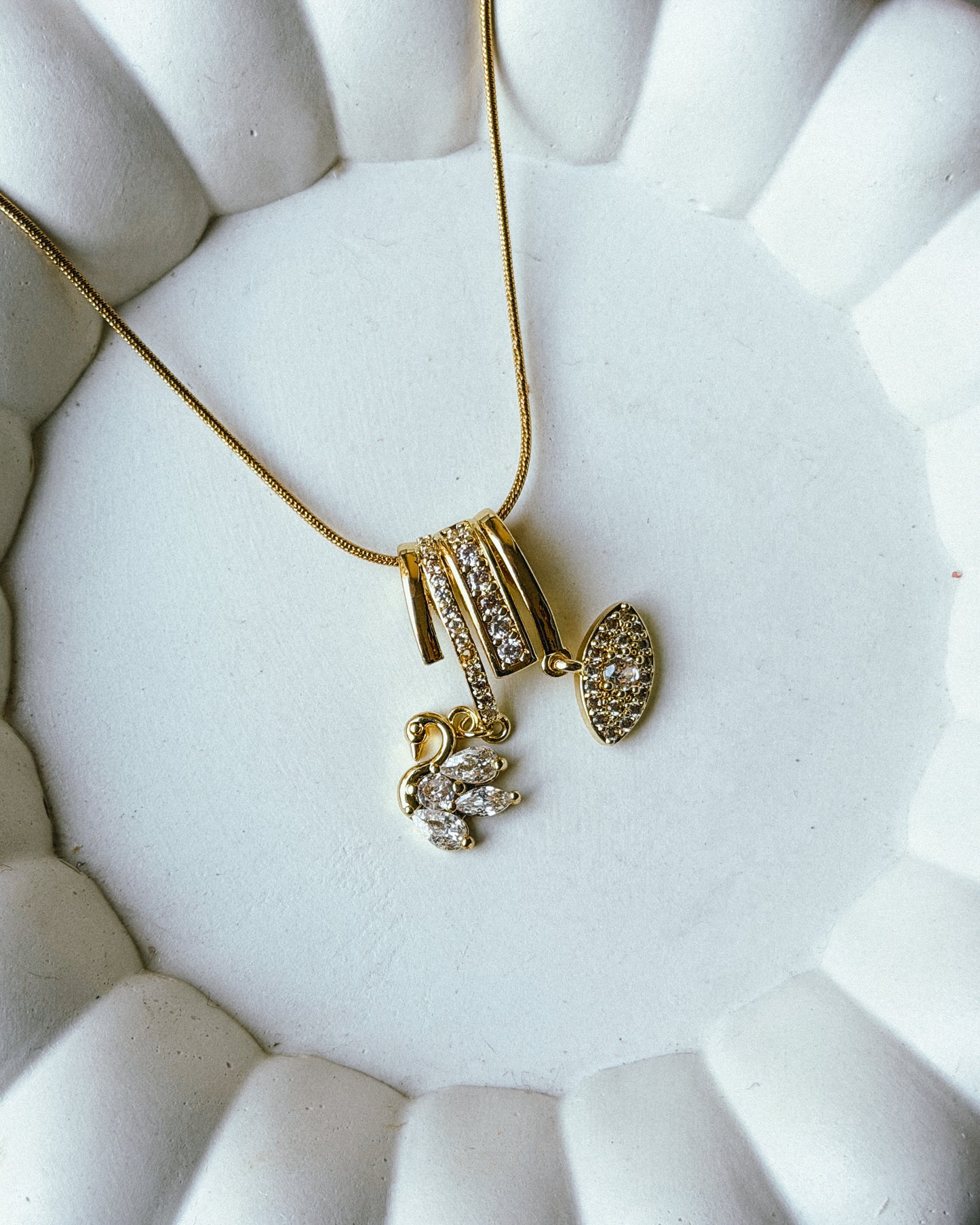 Studded bird eye charm necklace