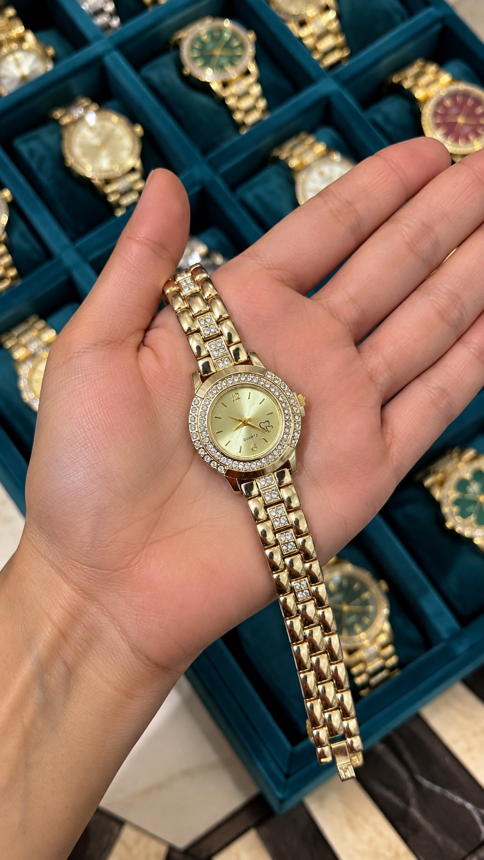 Golden round studded watch